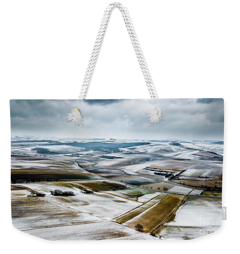 Above Weekender Tote Bag featuring the photograph Aerial View Of Winter Landscape With Remote Settlements And Snow Covered Fields In Austria by Andreas Berthold