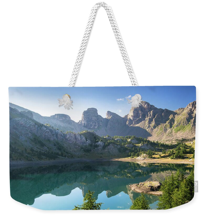 Allos Weekender Tote Bag featuring the photograph Allos lake, mirror effect by Jean-Luc Farges