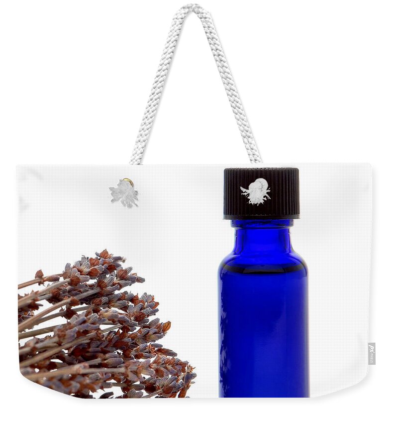 Aromatherapy Weekender Tote Bag featuring the photograph Aromatherapy Lavender Extract Essential Oil Bottle by Olivier Le Queinec