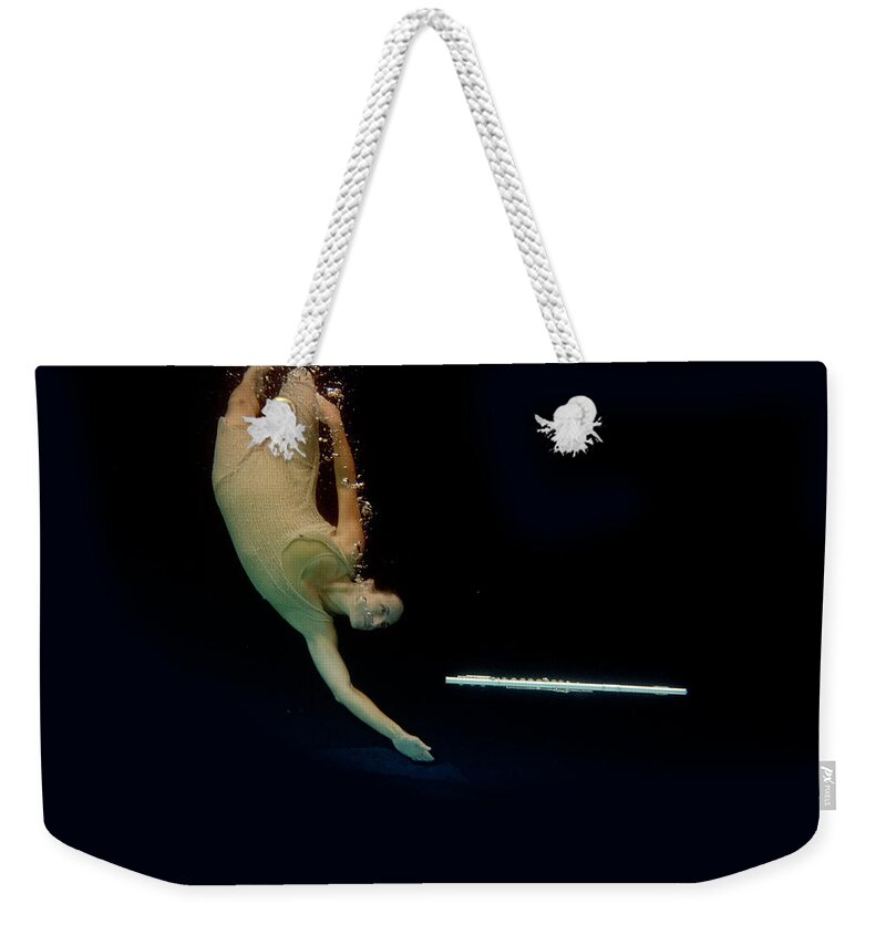 Artist Weekender Tote Bag featuring the photograph Artist magically floating with her flute 52 by Dan Friend