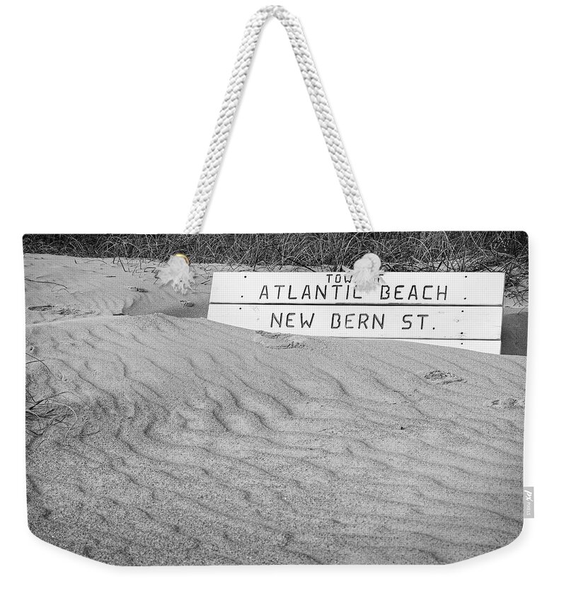 Atlantic Beach Weekender Tote Bag featuring the photograph Atlantic Beach Bench Partially Covered by Bob Decker