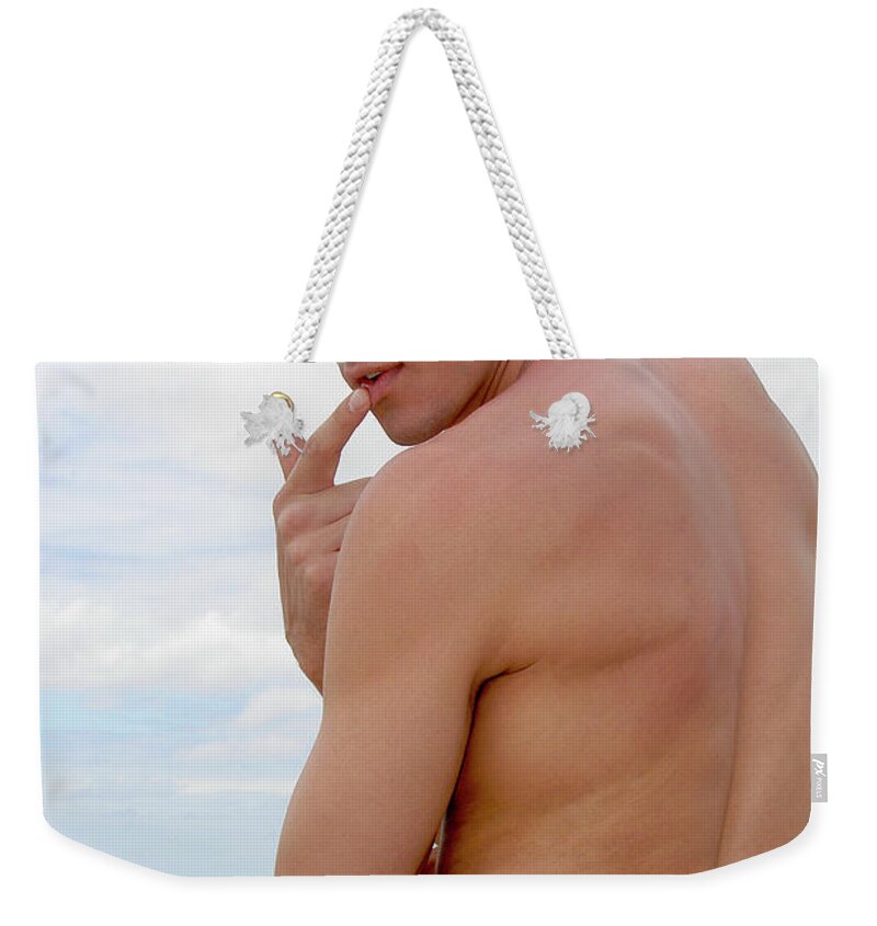 Beach Weekender Tote Bag featuring the photograph Attractive, muscular, and silly male model pulls down his pants... by Gunther Allen