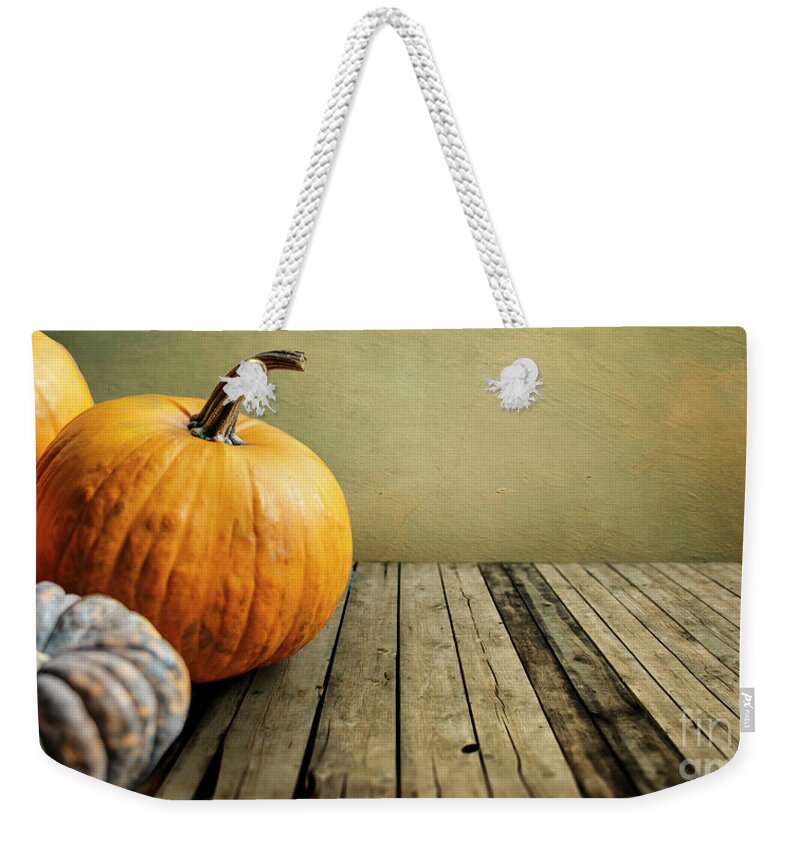 Thanksgiving Weekender Tote Bag featuring the photograph Autumn pumpkins still life on vintage wooden table and rustic ba by Jelena Jovanovic
