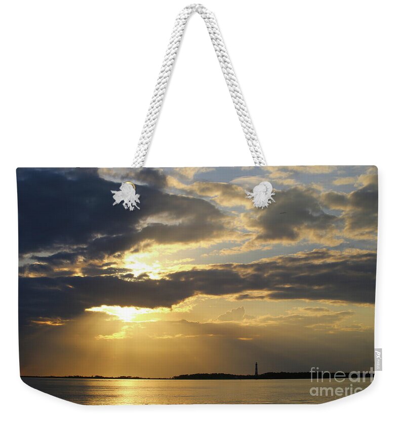 Cape Lookout Lighthouse Weekender Tote Bag featuring the photograph Beneath Golden Rays by Marty Fancy