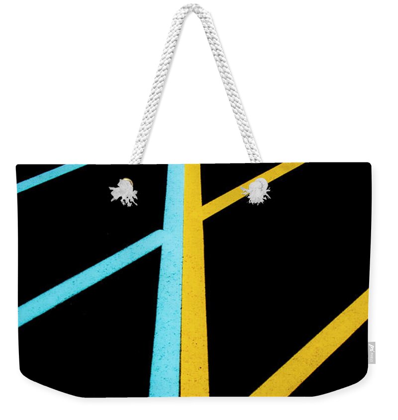 Traffic Lines Weekender Tote Bag featuring the photograph Blue And Yellow Traffic Lines Meet Along The Boarder by Gary Slawsky