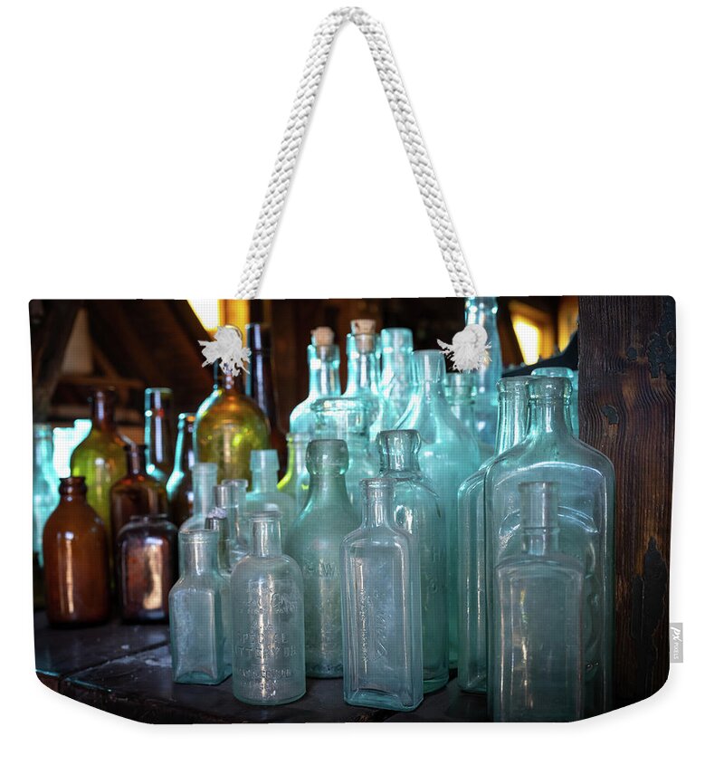 Old Weekender Tote Bag featuring the photograph Bottles by Mary Hone