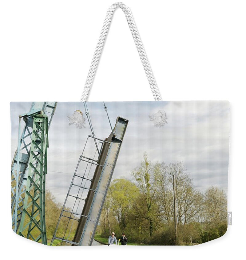 Transportation Weekender Tote Bag featuring the photograph Canal boat passing under the draw bridge, Pont levis a St Didier, Les Ilottes, Saint-Didier, Nievre, Burgundy, France by Kevin Oke