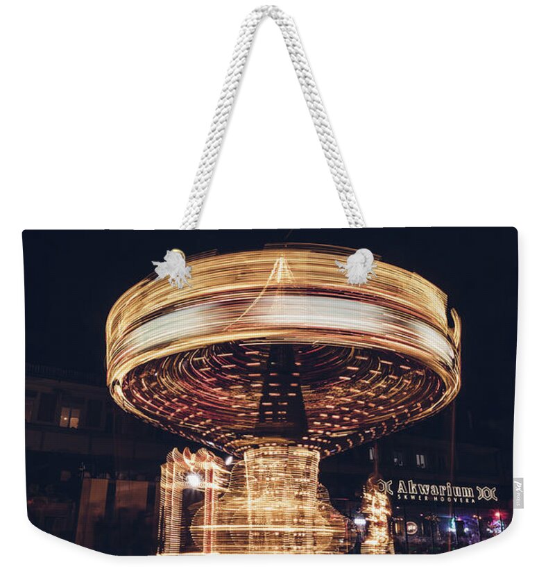 Illuminations Weekender Tote Bag featuring the photograph Christmas carousel on the streets of Warsaw. Fire Wheel by Vaclav Sonnek