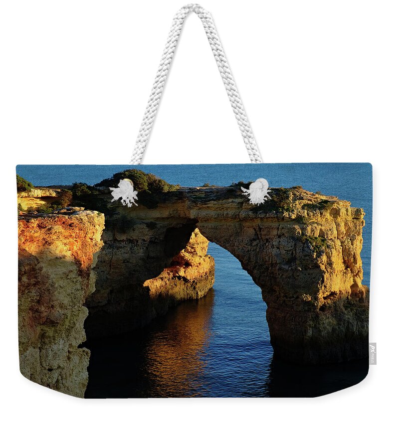 Algarve Weekender Tote Bag featuring the photograph Cliff Arch in Albandeira Beach during Sunset 2 by Angelo DeVal