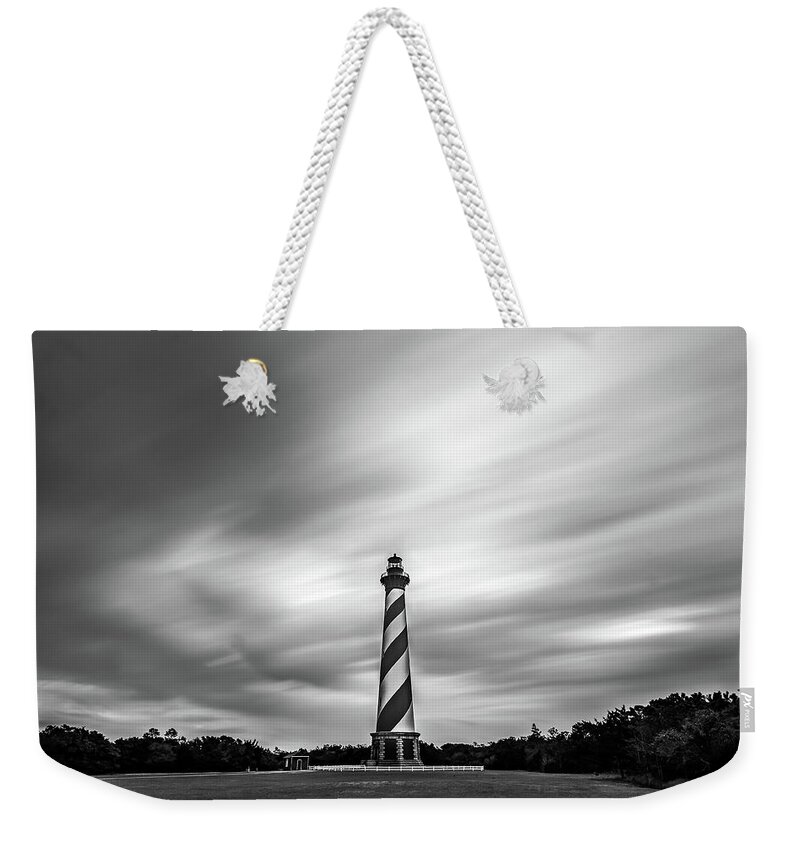 North Carolina Weekender Tote Bag featuring the photograph Clouds and lighthouse at Outer Banks, North Carolina by Robert Miller