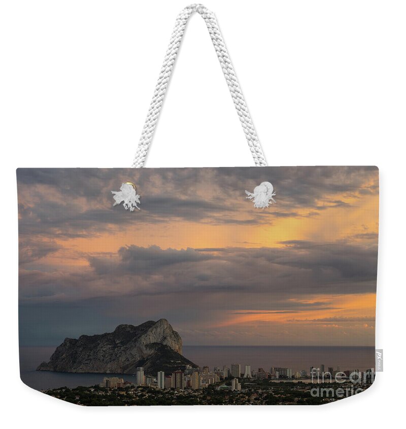 Sunset Weekender Tote Bag featuring the photograph Clouds on the Mediterranean coast in Calpe by Adriana Mueller
