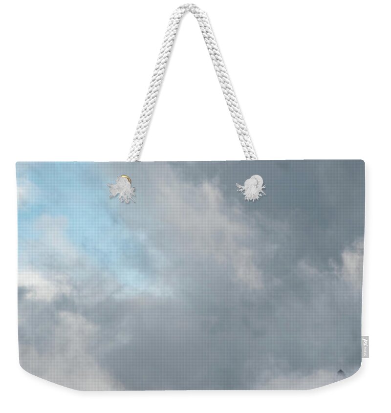 Italian Alps Weekender Tote Bag featuring the photograph Cloudy landscape with edge of rocky mountains between the stormy sky by Michalakis Ppalis