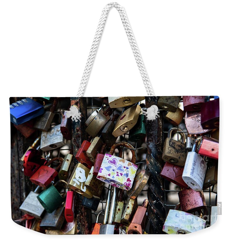 Attached Weekender Tote Bag featuring the photograph Colorful Love Padlocks Attached On Iron Fence by Andreas Berthold