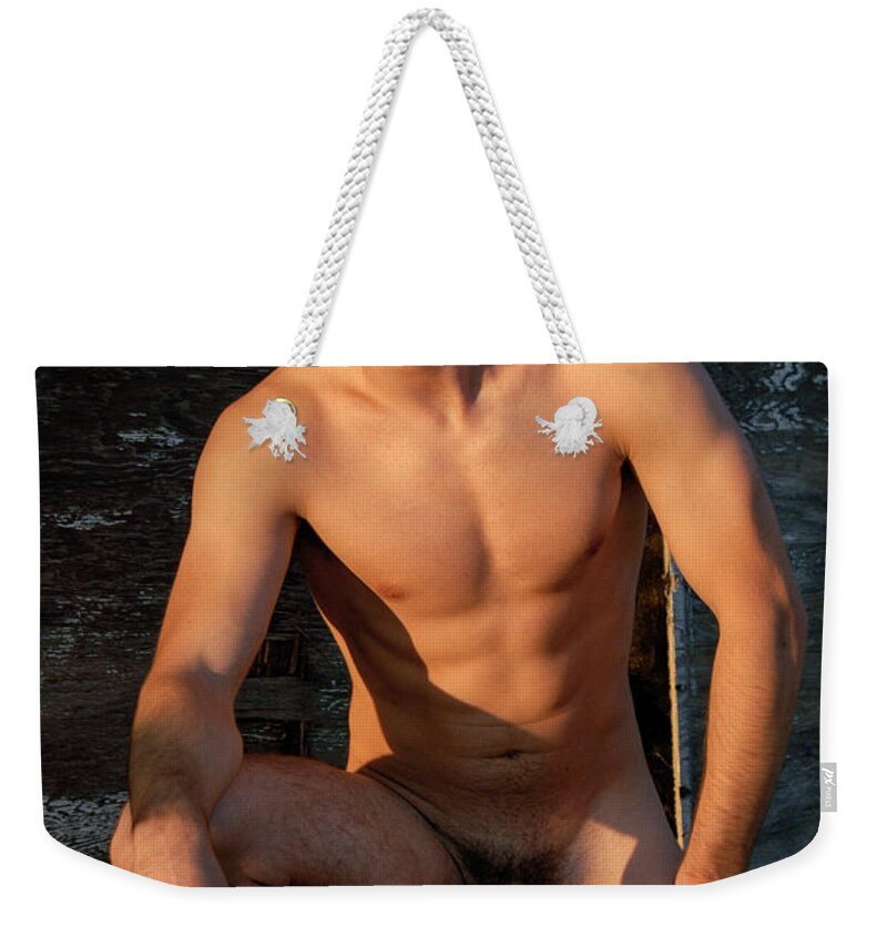 Male Art Weekender Tote Bag featuring the photograph Cowboy in the nude poses taking a knee down. by Gunther Allen