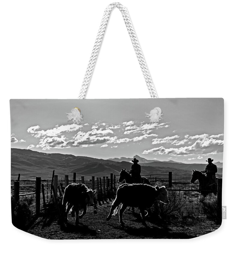 Ranch Weekender Tote Bag featuring the photograph Cowboys gatthering cows by Julieta Belmont