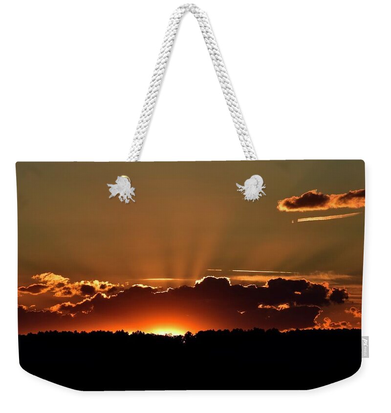 Crepuscular Weekender Tote Bag featuring the photograph Crepuscular rays at sunset by Monika Salvan