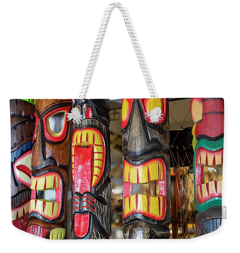 Tiki Mask Weekender Tote Bag featuring the photograph Decorative Tiki Masks by Dart Humeston