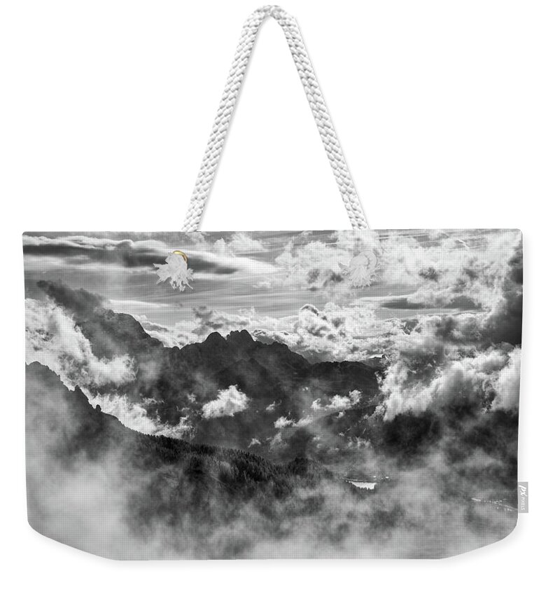 Mountain Weekender Tote Bag featuring the photograph Dramatic Stormy sky and the mountain peaks of the Dolomites in S by Michalakis Ppalis