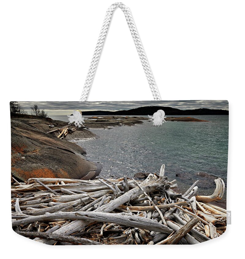 Coast Weekender Tote Bag featuring the photograph Driftwood Dilemma by Doug Gibbons