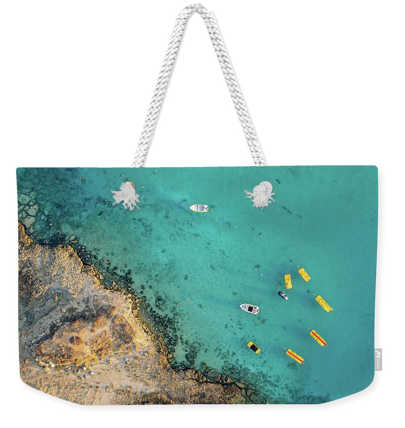 Seascape Weekender Tote Bag featuring the photograph Drone aerial of seascape with idyllic blue calm blue water. Fig tree bay beach Protaras Cyprus by Michalakis Ppalis