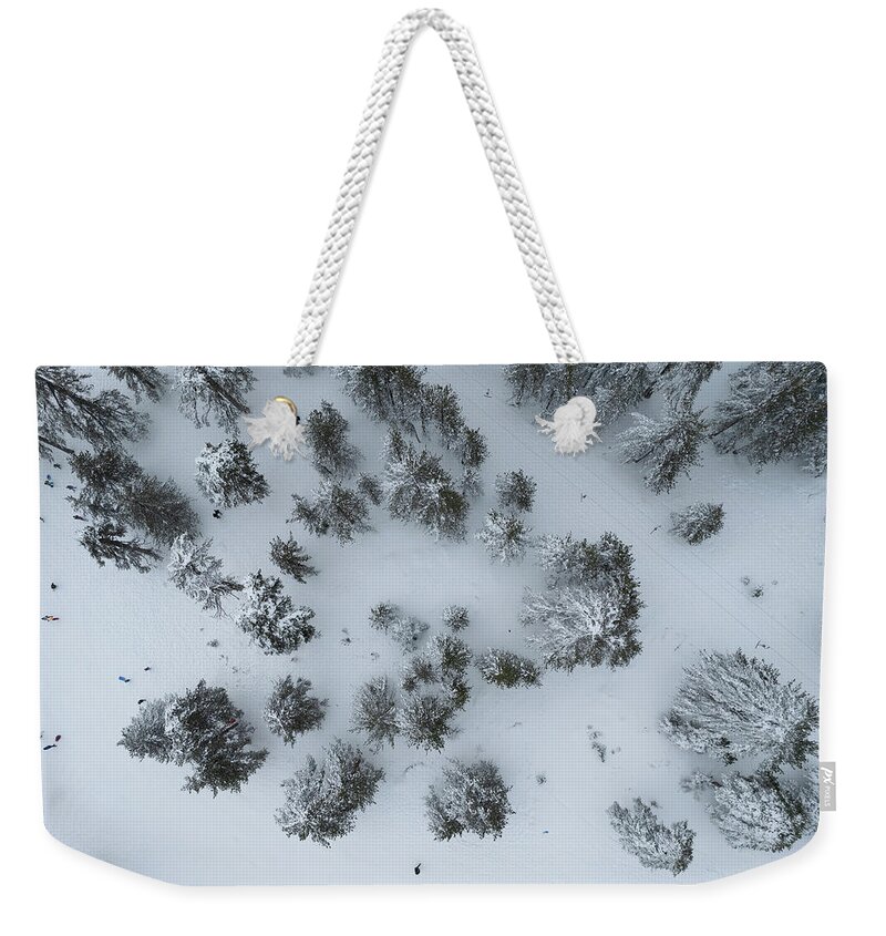 Winter Weekender Tote Bag featuring the photograph Drone aerial scenery of mountain snowy forest and people playing in snow. Wintertime season by Michalakis Ppalis