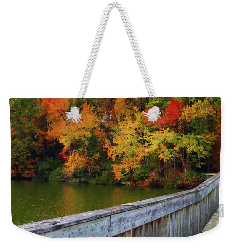 Foliage Weekender Tote Bag featuring the photograph Fiery Foliage Beyond the Bridge by Ola Allen