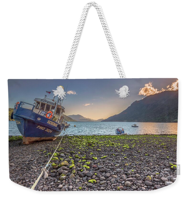 Chile Weekender Tote Bag featuring the photograph Fishing boat moored in the Hornopiren fjord at golden hour by Henri Leduc