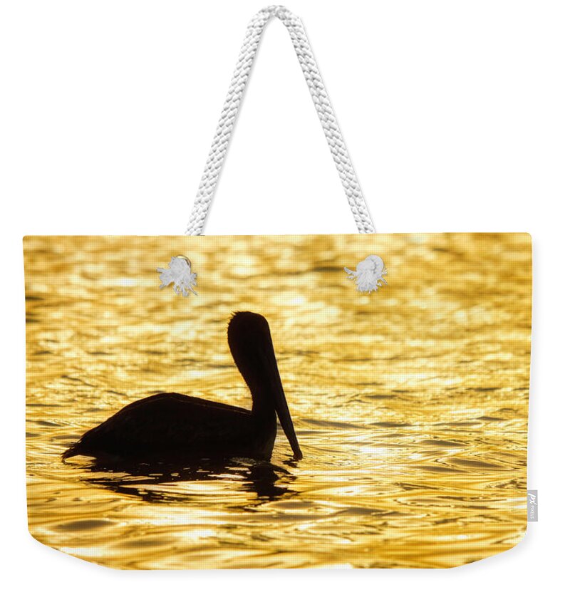 Pelican Weekender Tote Bag featuring the photograph Floating in gold by Tatiana Travelways