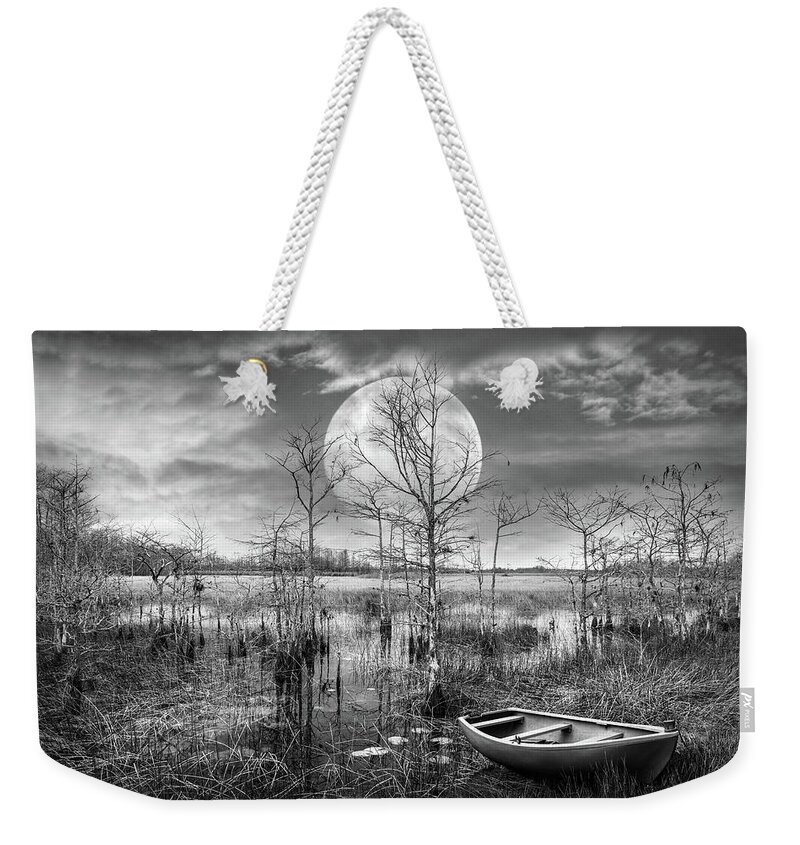Boats Weekender Tote Bag featuring the photograph Floating Under the Full Moon in Black and White by Debra and Dave Vanderlaan