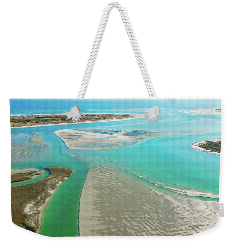 Inlet Weekender Tote Bag featuring the photograph Flowing out by Sand Catcher