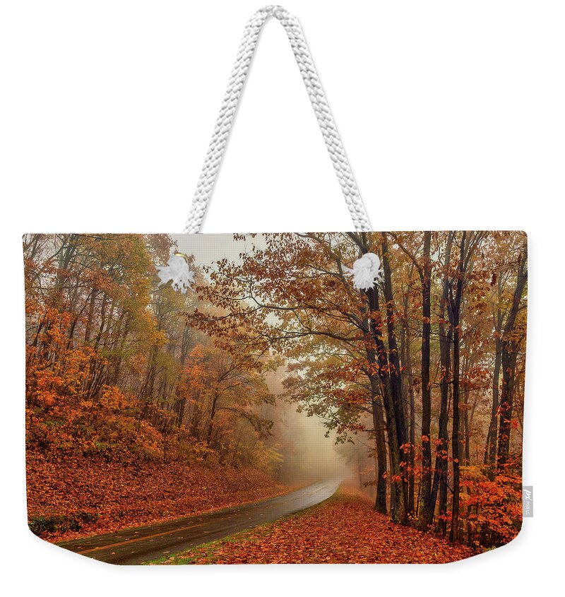 Autumn Weekender Tote Bag featuring the photograph Foggy Autumn Parkway by Dan Carmichael
