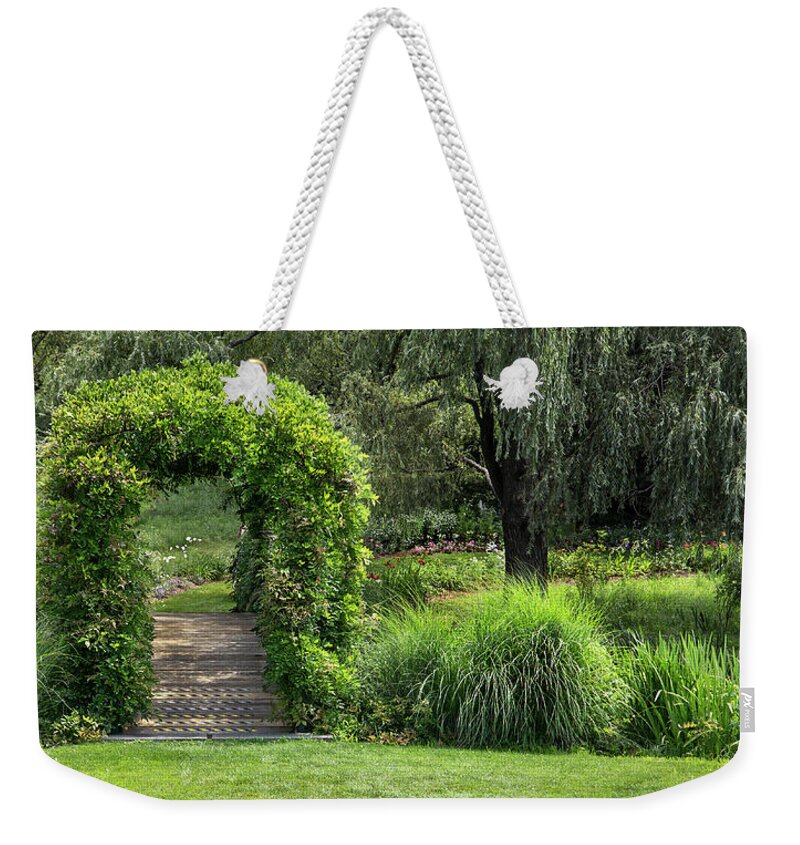 Nature Weekender Tote Bag featuring the photograph Garden trellis over foot bridge. by Phil Cardamone