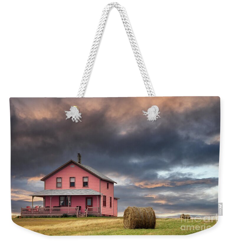 Typical Weekender Tote Bag featuring the photograph rchitecture of the Magdalen Islands, where all the wooden houses are brightly painted. Sunset shot of a house on the hill. Image taken from a public position. by Jane Rix