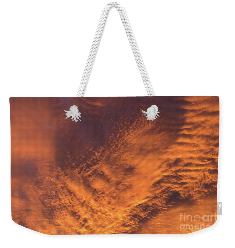 Clouds Weekender Tote Bag featuring the photograph Glowing sunset sky with deep orange clouds by Adriana Mueller