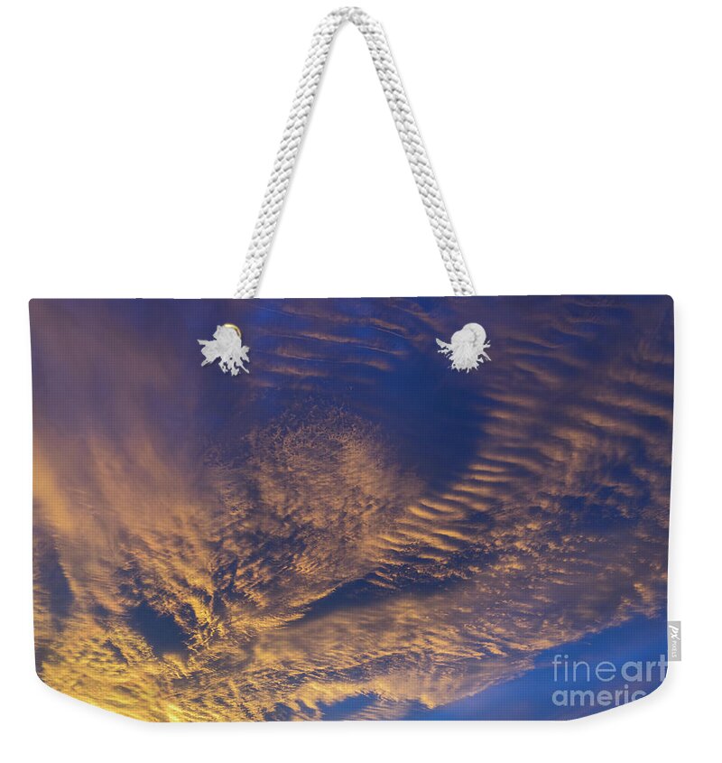 Clouds Weekender Tote Bag featuring the photograph Golden and dark blue cloudscape at sunset by Adriana Mueller