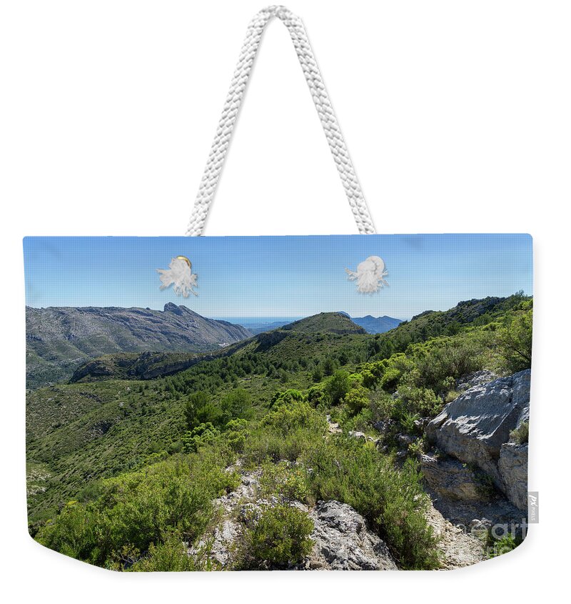 Mountain Weekender Tote Bag featuring the photograph Green mountain landscape and the rock Cavall Verd by Adriana Mueller