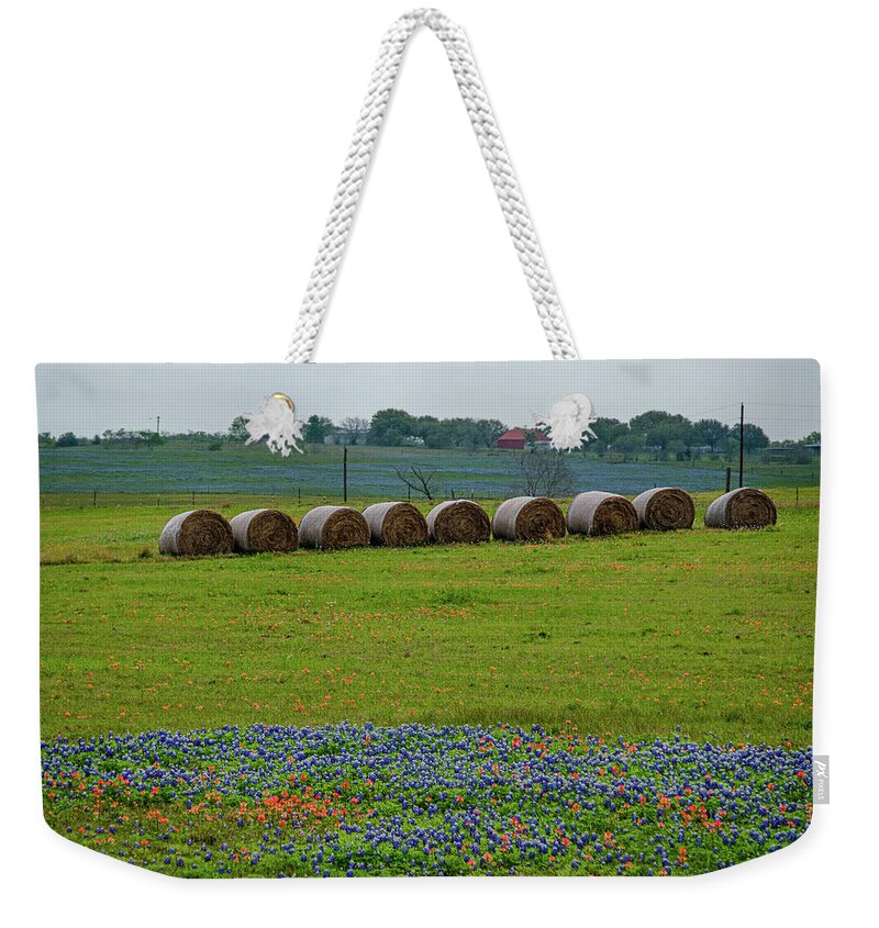 Texas Bluebonnets Weekender Tote Bag featuring the photograph Hay Bales and Blues by Johnny Boyd