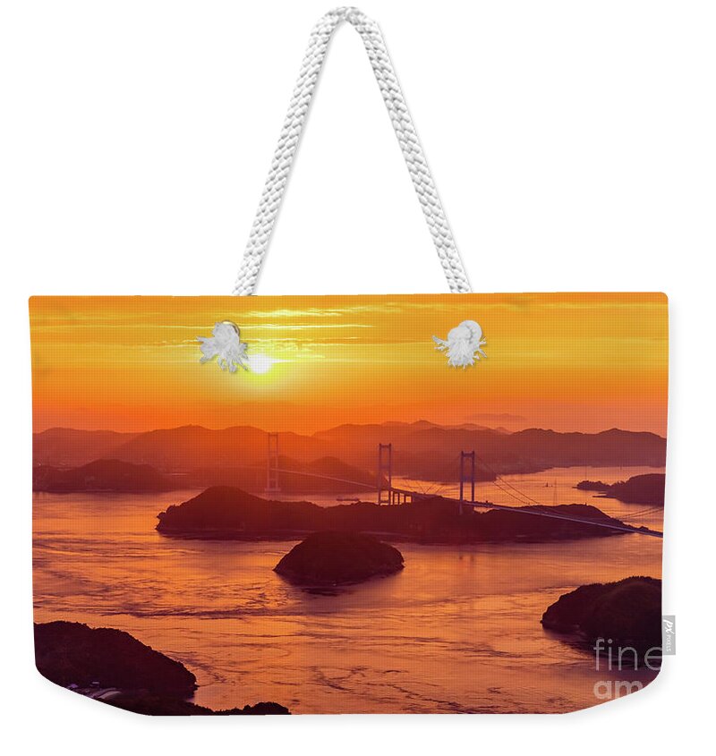 Sunset Weekender Tote Bag featuring the photograph Hazy sunset on Kurushima Kaikyo Bridge and Kurushima Strait by Lyl Dil Creations