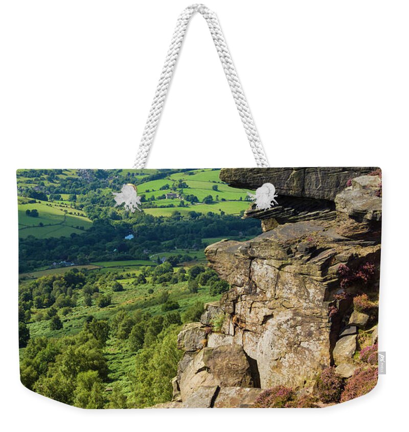 Derbyshire Weekender Tote Bag featuring the photograph Hiker standing alone on Froggatt Edge, Derbyshire Peak District National Park, England by Neale And Judith Clark