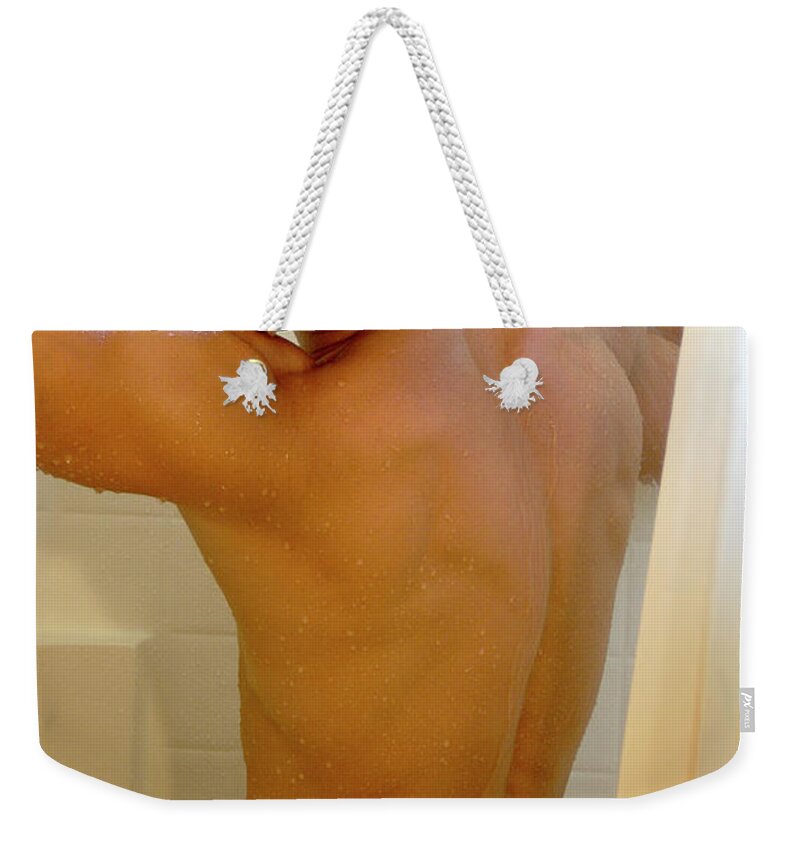 Nude Weekender Tote Bag featuring the photograph Hot naked man in the shower by Gunther Allen