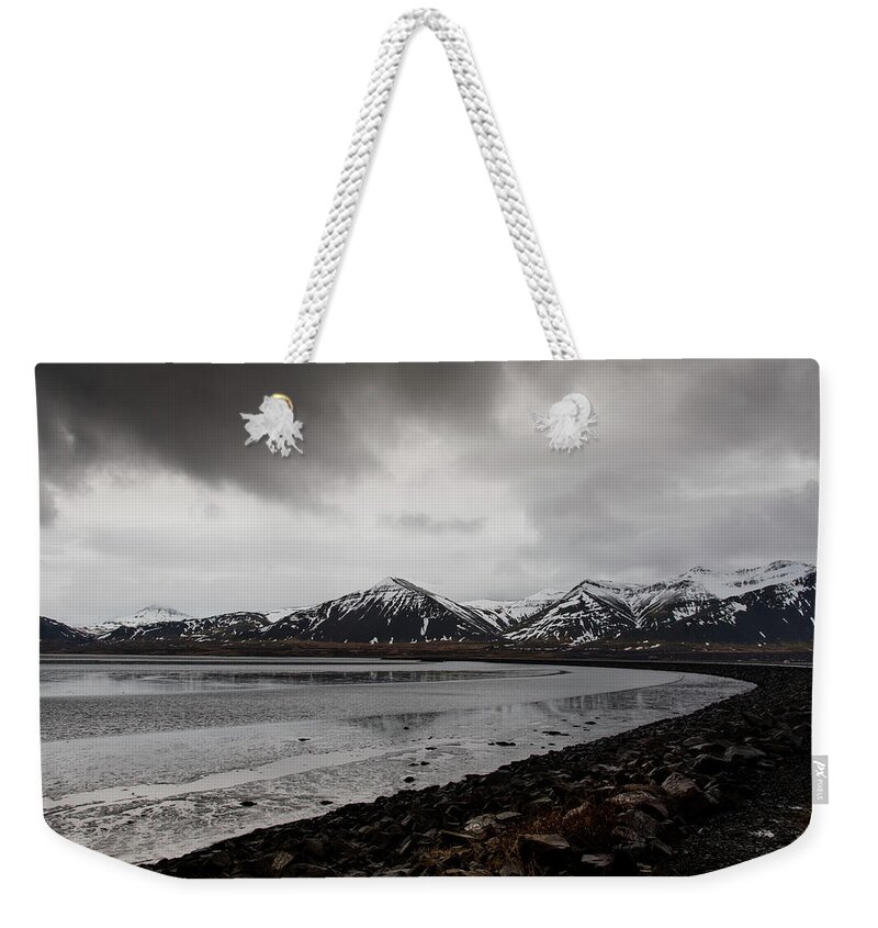 Iceland Weekender Tote Bag featuring the photograph Icelandic landscape with frozen lake and mountains covered in snow by Michalakis Ppalis