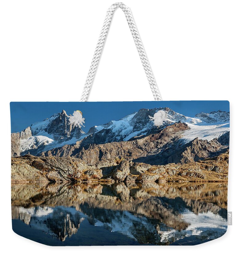 Lake Weekender Tote Bag featuring the photograph La Meije peak mirrored in Lake Lerie by Olivier Parent