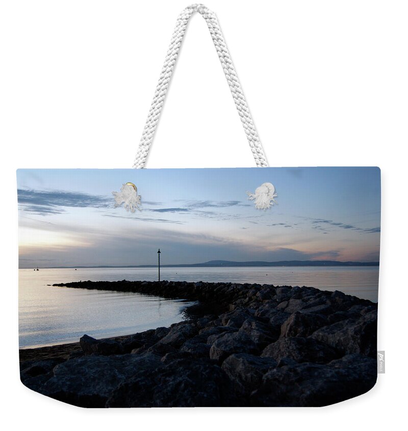 Lancashire Weekender Tote Bag featuring the photograph LANCASHIRE, Morecambe. A Breakwater On The Bay. by Lachlan Main