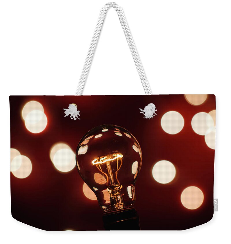 Light Bulb Weekender Tote Bag featuring the photograph Light Bulb Bokeh by Gary Geddes