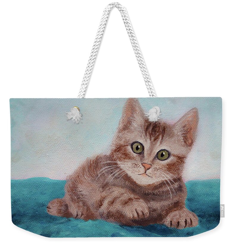 Cute Weekender Tote Bag featuring the painting Little Tabby Cat Painting, a Cute Kitty Lying on a Blue Blanket by Aneta Soukalova