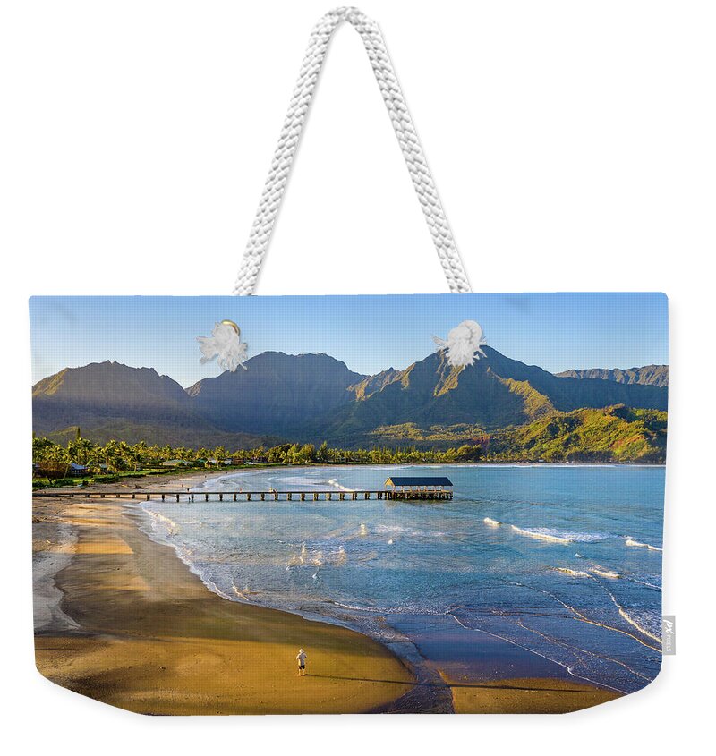 Aerial Weekender Tote Bag featuring the photograph Lone man on the sand of Hanalei beach on the nor by Steven Heap