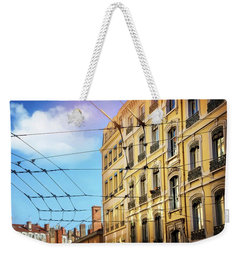 Lyon Weekender Tote Bag featuring the photograph Lyon France Through a Web of Tram Lines by Carol Japp
