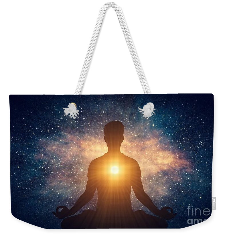 Yoga Weekender Tote Bag featuring the photograph Man and soul. Yoga lotus pose meditation on nebula galaxy background by Michal Bednarek