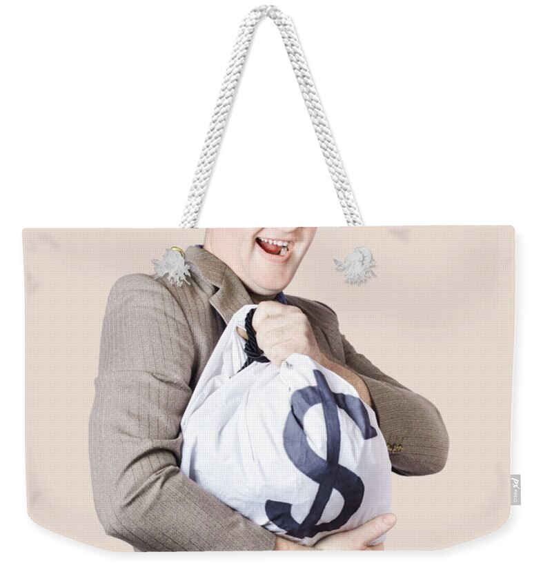 Money Weekender Tote Bag featuring the photograph Man holding large sum of money in bank deposit bag by Jorgo Photography
