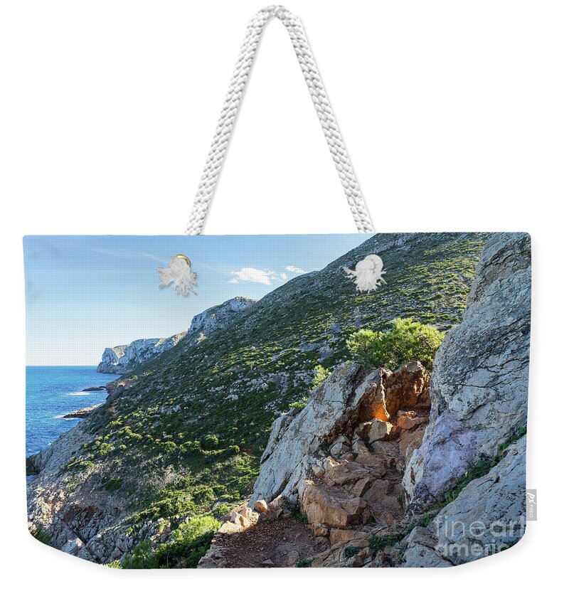 Mediterranean Coast Weekender Tote Bag featuring the photograph Mediterranean coast and rocks in Spain by Adriana Mueller